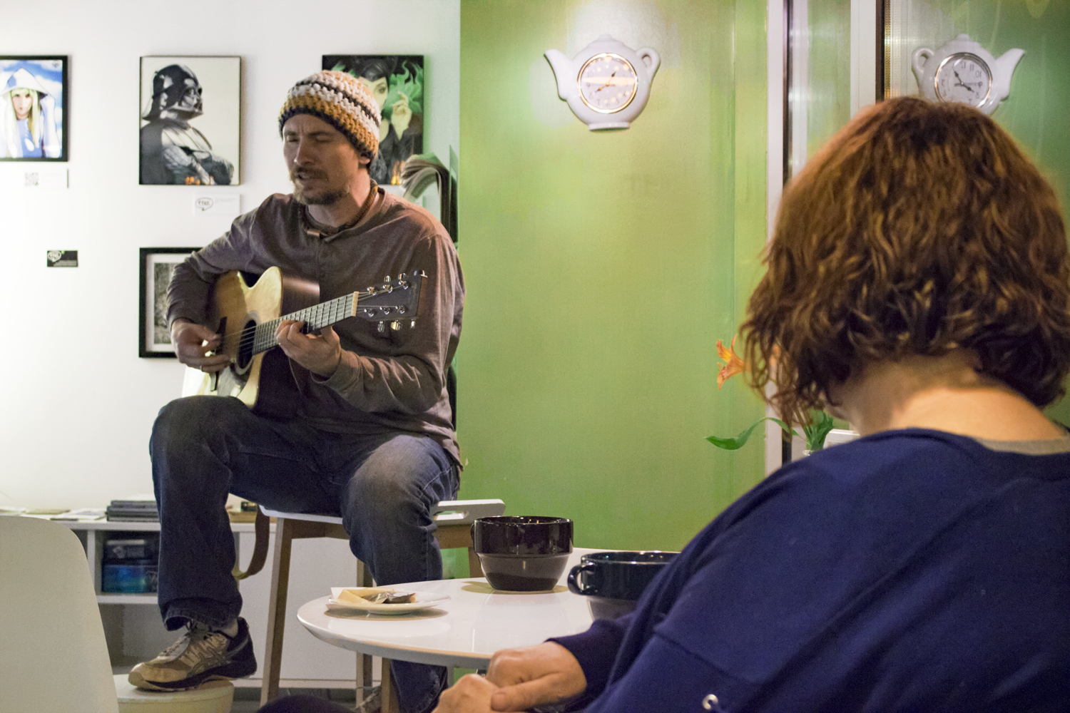 Adam Kiraly playing guitar and singing for O-Cha Custoers