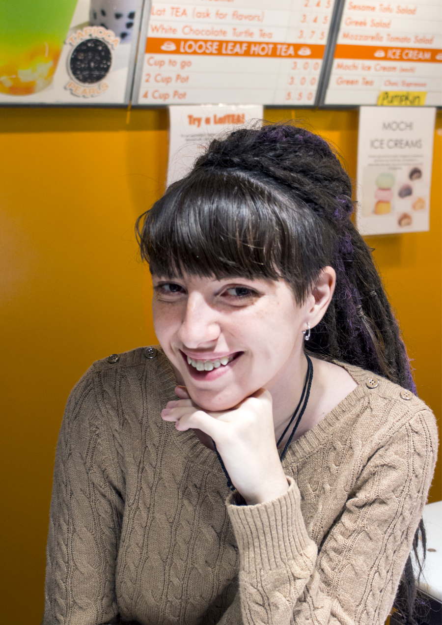 O-Cha employee smiling standing behind front counter