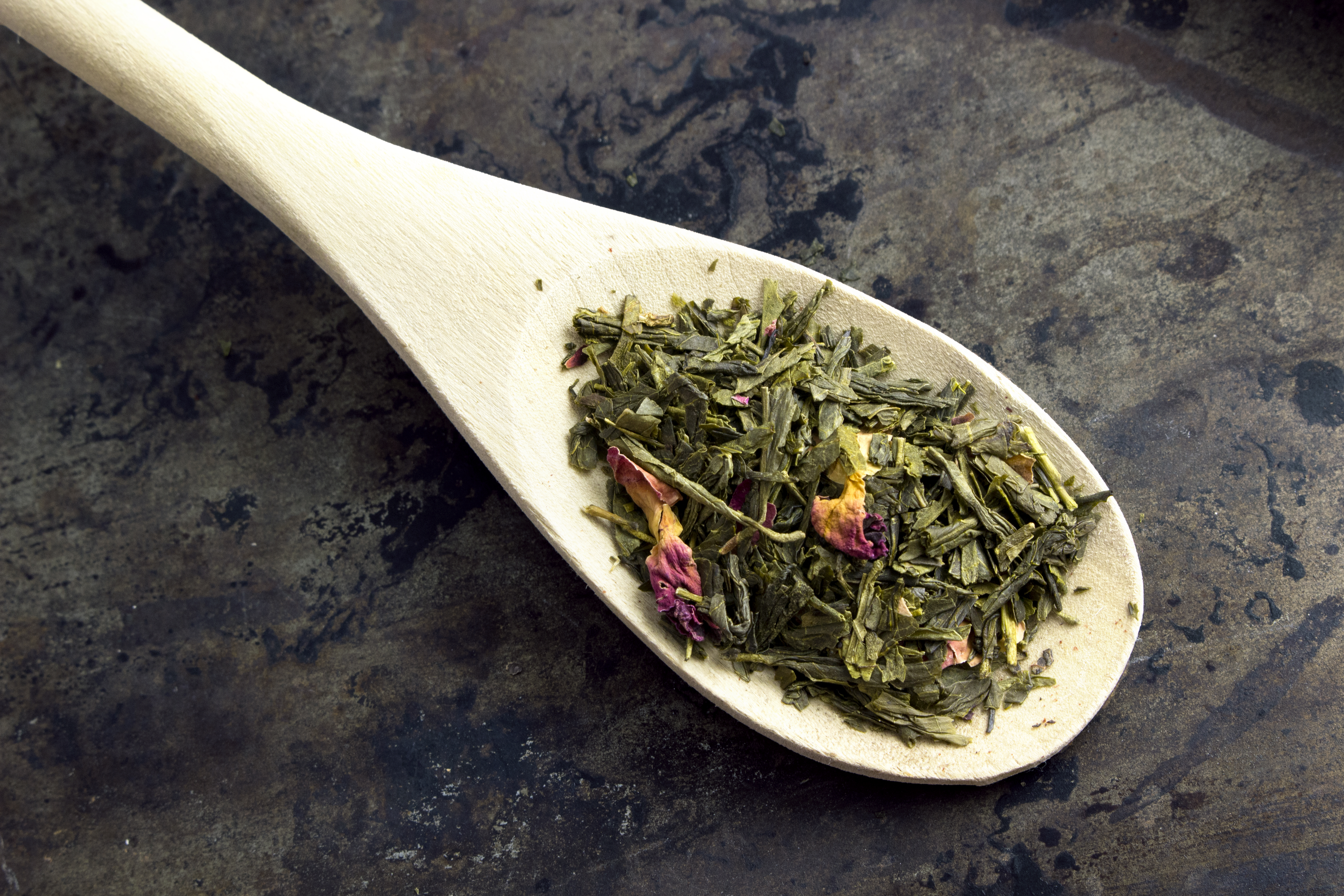Wooden spoon with scoop of Kyoto Cherry Rose green tea